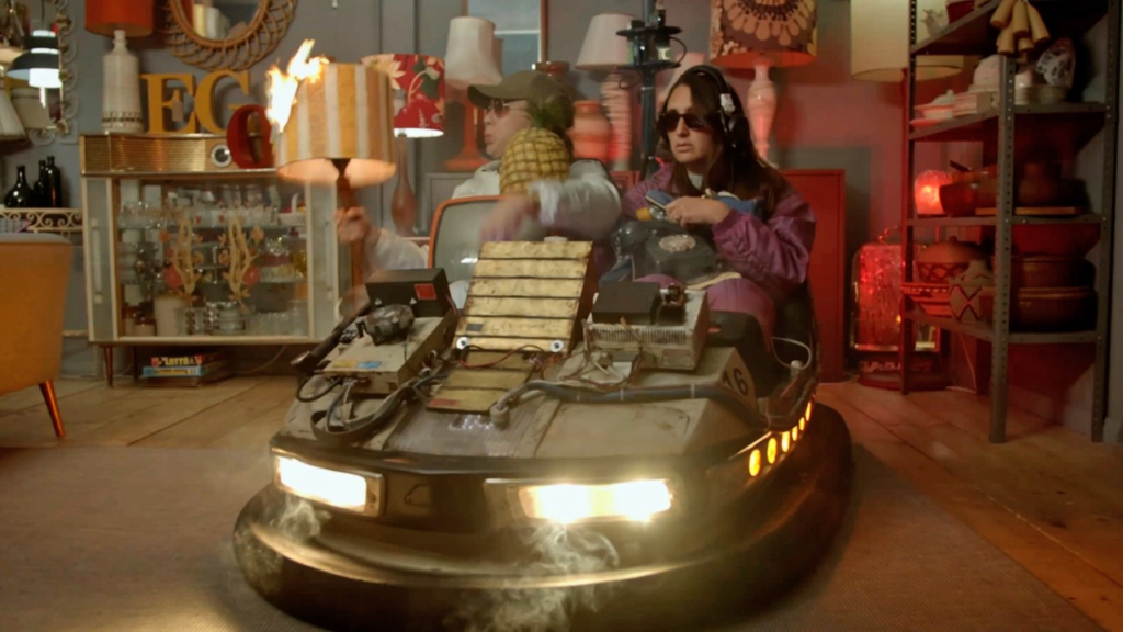 Oh look, it's the time machine ne bumper car with two young ladies in it. They appear to be returning from a shopping spree. Edina and Patsy would be proud of their casual style, although there isn't anything to drink nearby at all.